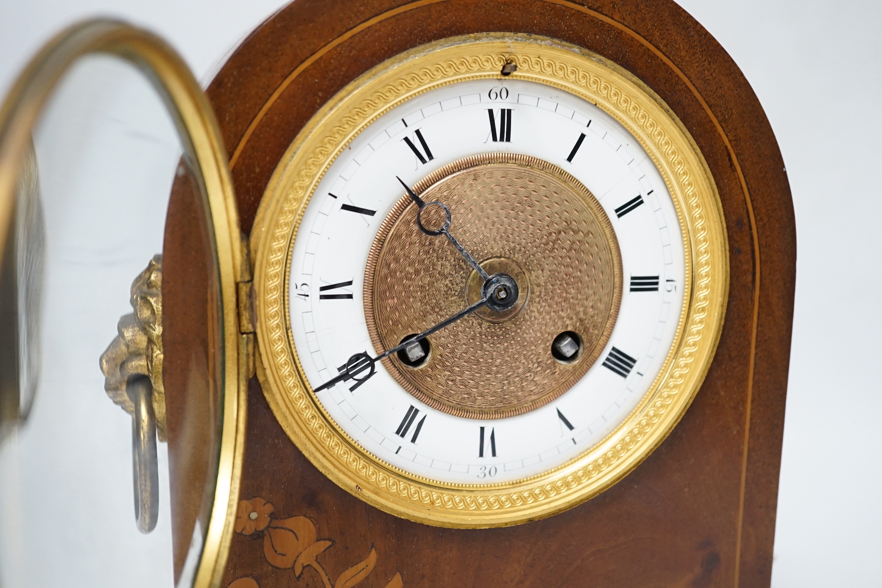 An Edwardian mahogany mantel clock, French movement striking on a coiled gong, 25cm high